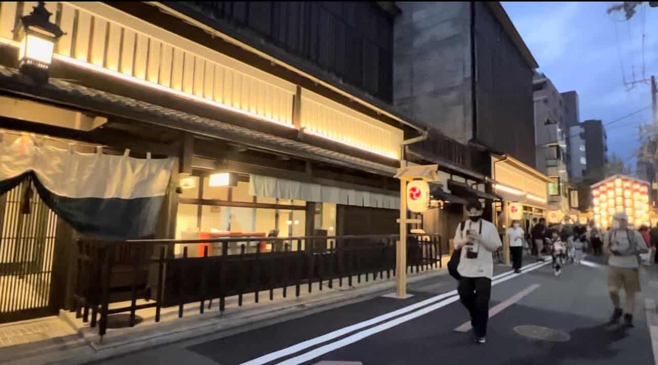 Traditional-looking facades lit with Japanese lanterns in the Ennogyoja Yama neighborhood during Kyoto's Gion Matsuri.