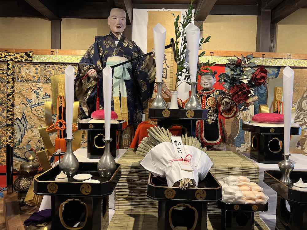 Offerings in font of sacred statues and textile treasures in Kakkyo Yama's newly refurbished kaisho meeting place.