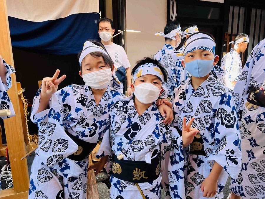 Young boys wearing Gion Festival yukata and covid masks enjoy posing for the camera.